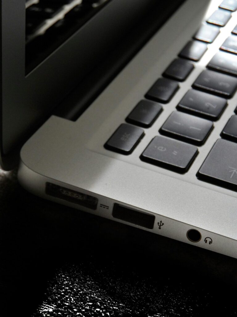 Free Detailed view of a silver laptop showing keyboard and multiple ports. Stock Photo